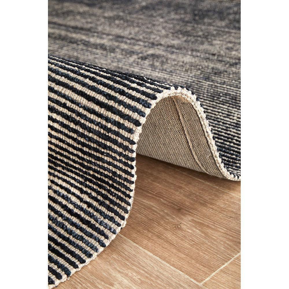 Allie Black Cotton Rayon Rug featuring striped pattern in black and cream on warm wood floor, machine-made from Rug Culture Allure Collection