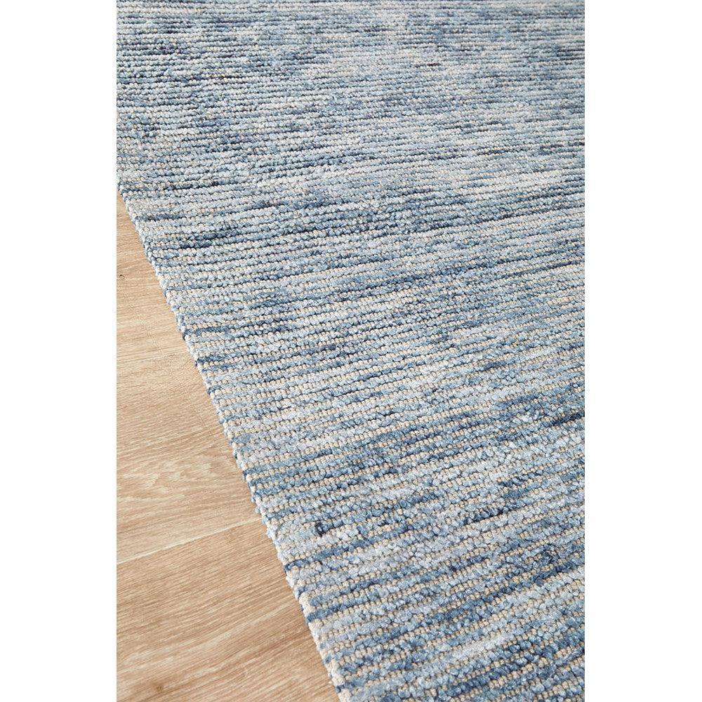 Allie Indigo Cotton Rayon Rug featuring striped pattern in indigo, navy, sky blue and cream on warm beige wood, machine-woven cotton-rayon