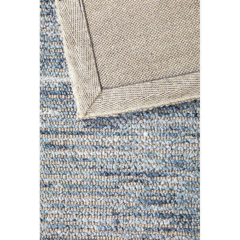 Allie Indigo Cotton Rayon Rug featuring textured loop weave in indigo and beige on light tan background, woven cotton-rayon