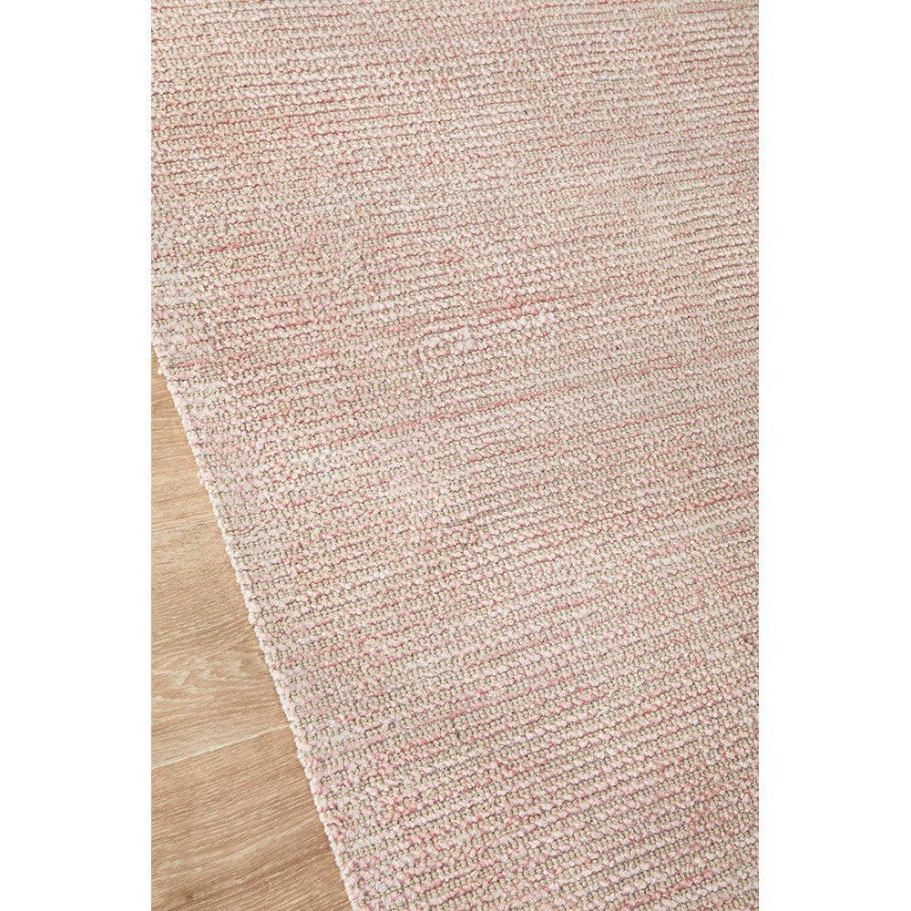 Allie Rose Cotton Rayon Rug featuring textured pink weave in blush, rose and dusty pink on natural wood background, woven cotton-rayon