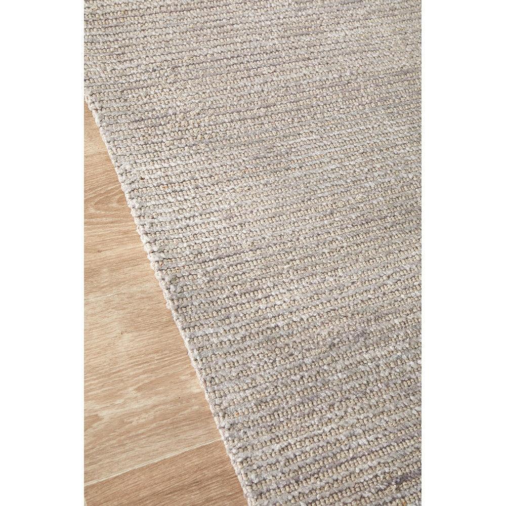 Allie Stone Cotton Rayon Rug featuring textured loop-weave in beige taupe on warm wood background, handcrafted rug
