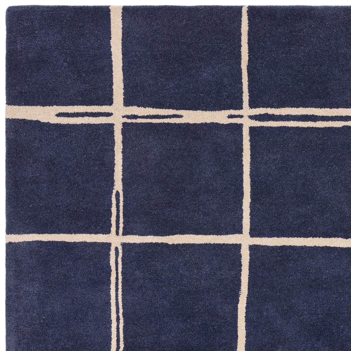 Asiatic Albany Grid Marine Designer Rug with geometric grid in navy blue and cream on navy background, hand-tufted wool