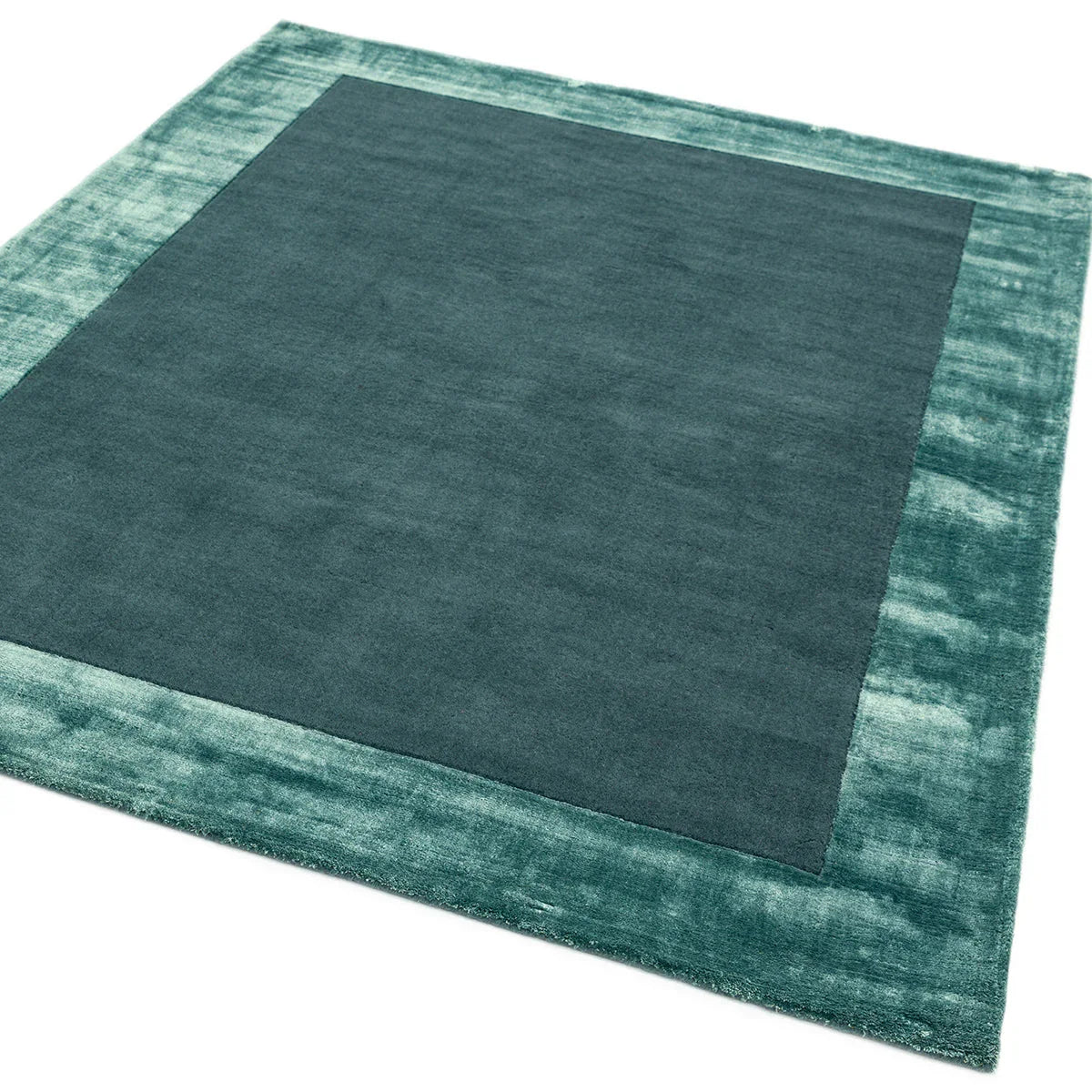 Asiatic Ascot Aqua Blue Designer Rug featuring solid deep-teal field with teal border in aqua on white, hand-tufted wool
