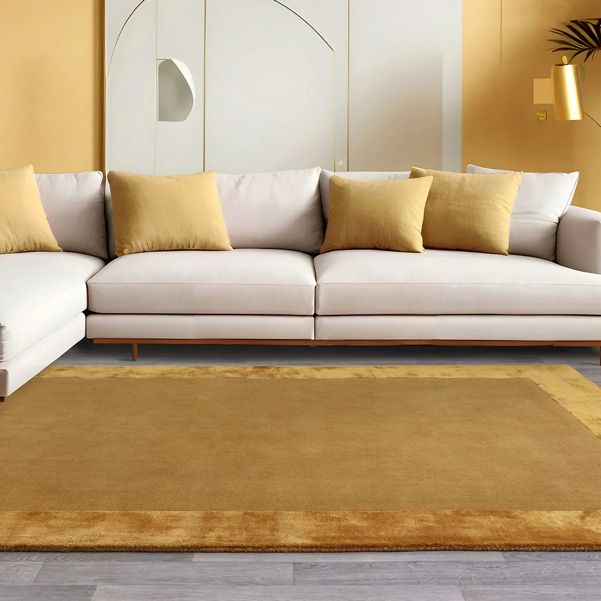 Asiatic Ascot Gold Designer Rug featuring gold field with border in honey ochre on grey floor, hand-tufted wool