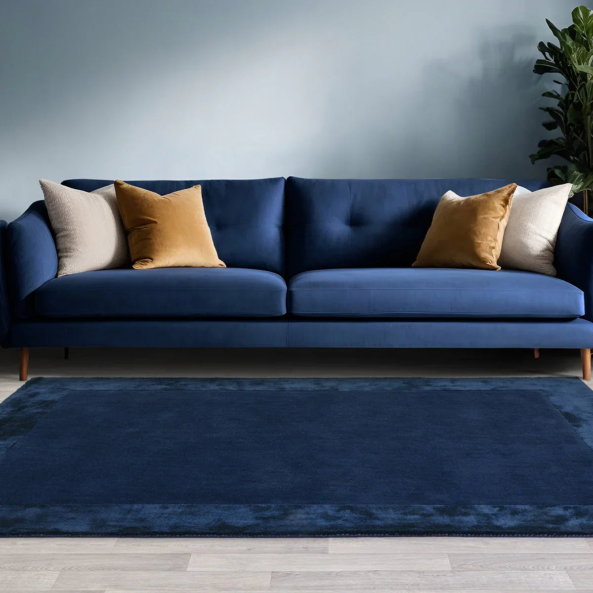 Asiatic Ascot Navy Designer Rug featuring solid colour in navy blue, beige and cream on beige wood floor, tufted wool