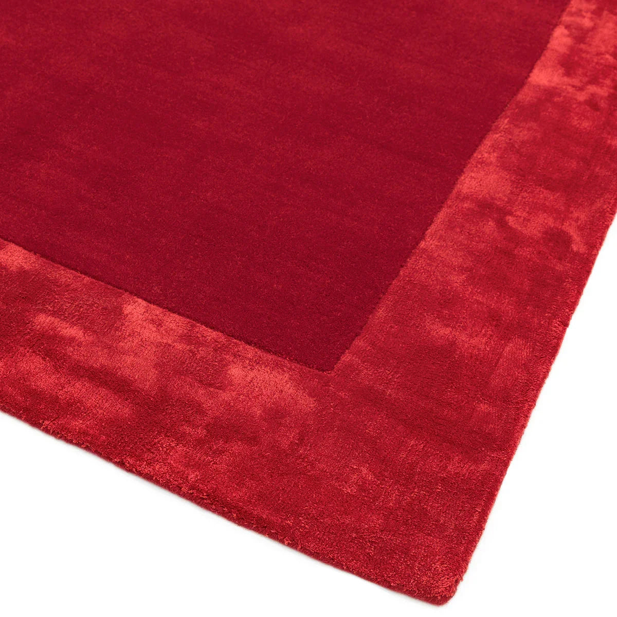 Asiatic Ascot Red Designer Rug featuring solid red field with a plush, dense pile and a lighter red border