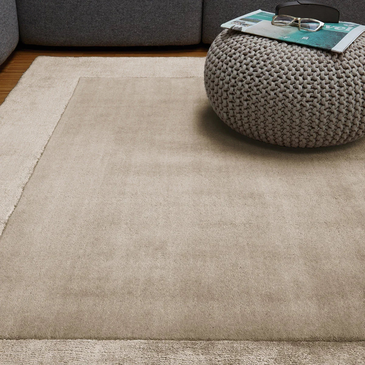 Asiatic Ascot Sand Designer Rug featuring solid-tone with cream border in sand beige on warm beige, machine-made wool