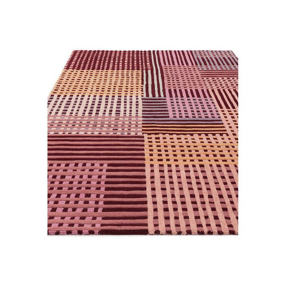 Asiatic Aspect Red Rug featuring patchwork geometric pattern in red, burgundy, pink, peach and cream on pink background, hand-tufted wool