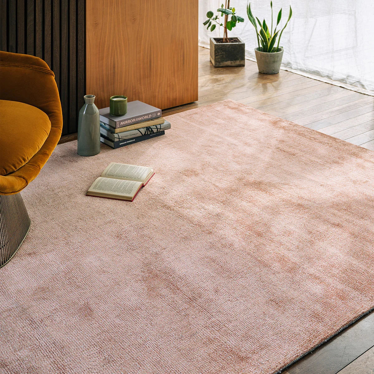 Asiatic Aston Copper Designer Rug featuring copper, peach and rose texture on light wood floor, machine-made wool
