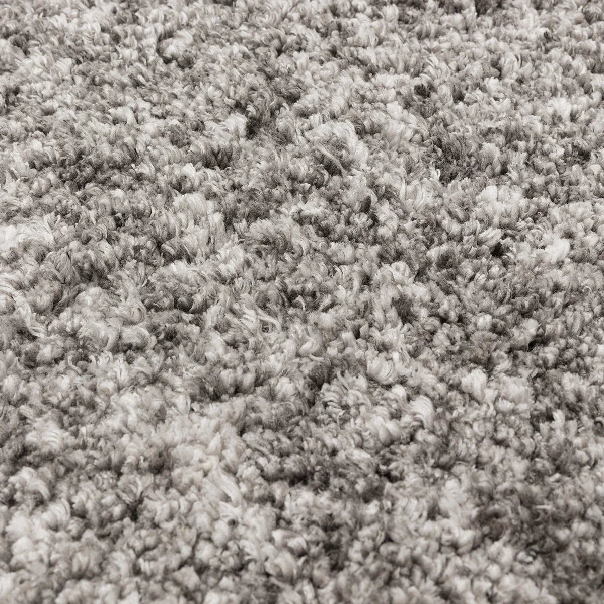 Asiatic Barnaby Grey Designer Rug, shaggy tufted pile in charcoal and slate on pale grey background, hand-tufted wool