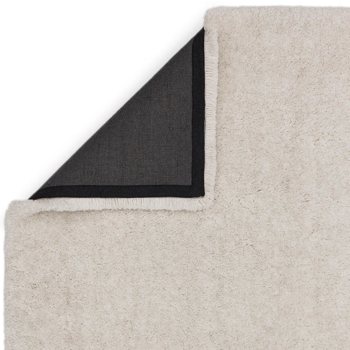 Asiatic Barnaby Off White Designer Rug featuring solid shag pile in cream/off-white with navy and black hand-tufted wool on white