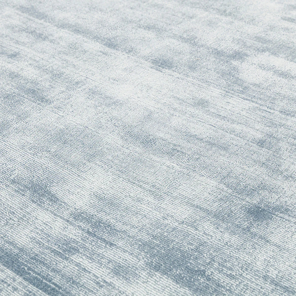 Asiatic Blade Airforce Blue Designer Rug with marbled pattern in airforce blue and ivory on grey backdrop, tufted wool