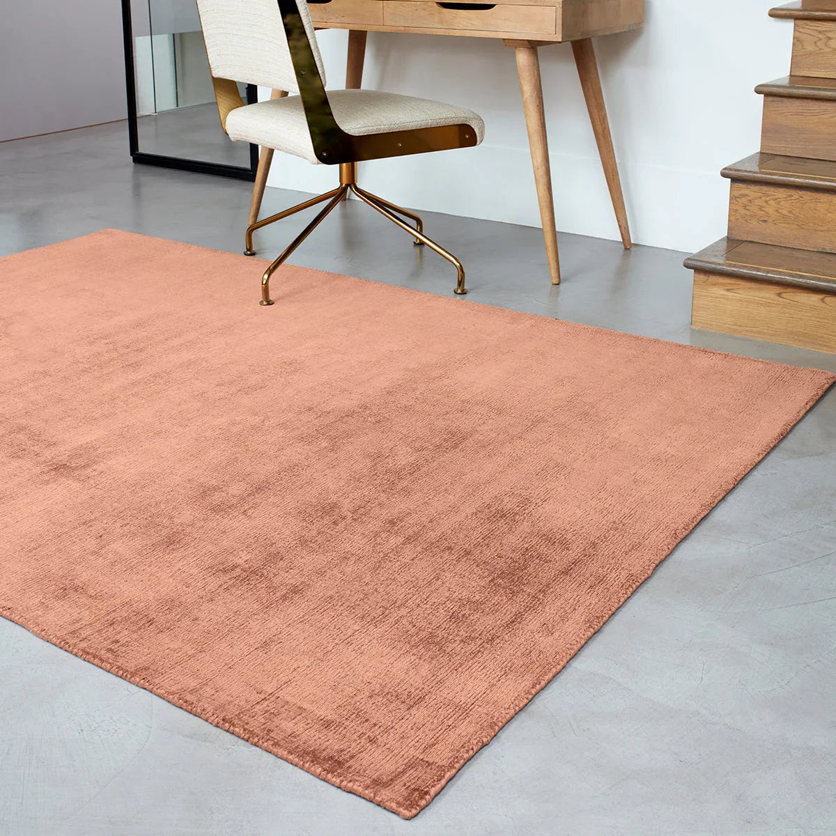 Asiatic Blade Earth Designer Rug featuring solid velvet-textured in terracotta, copper and blush on light grey floor, hand-tufted wool