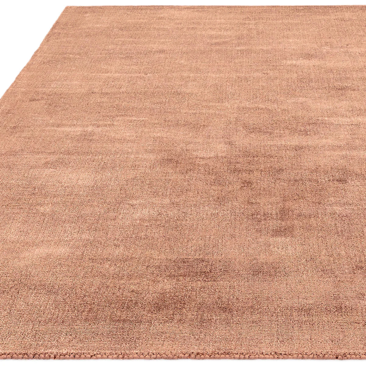 Asiatic Blade Earth Designer Rug featuring solid colour field in copper, terracotta bronze on white, machine-woven wool