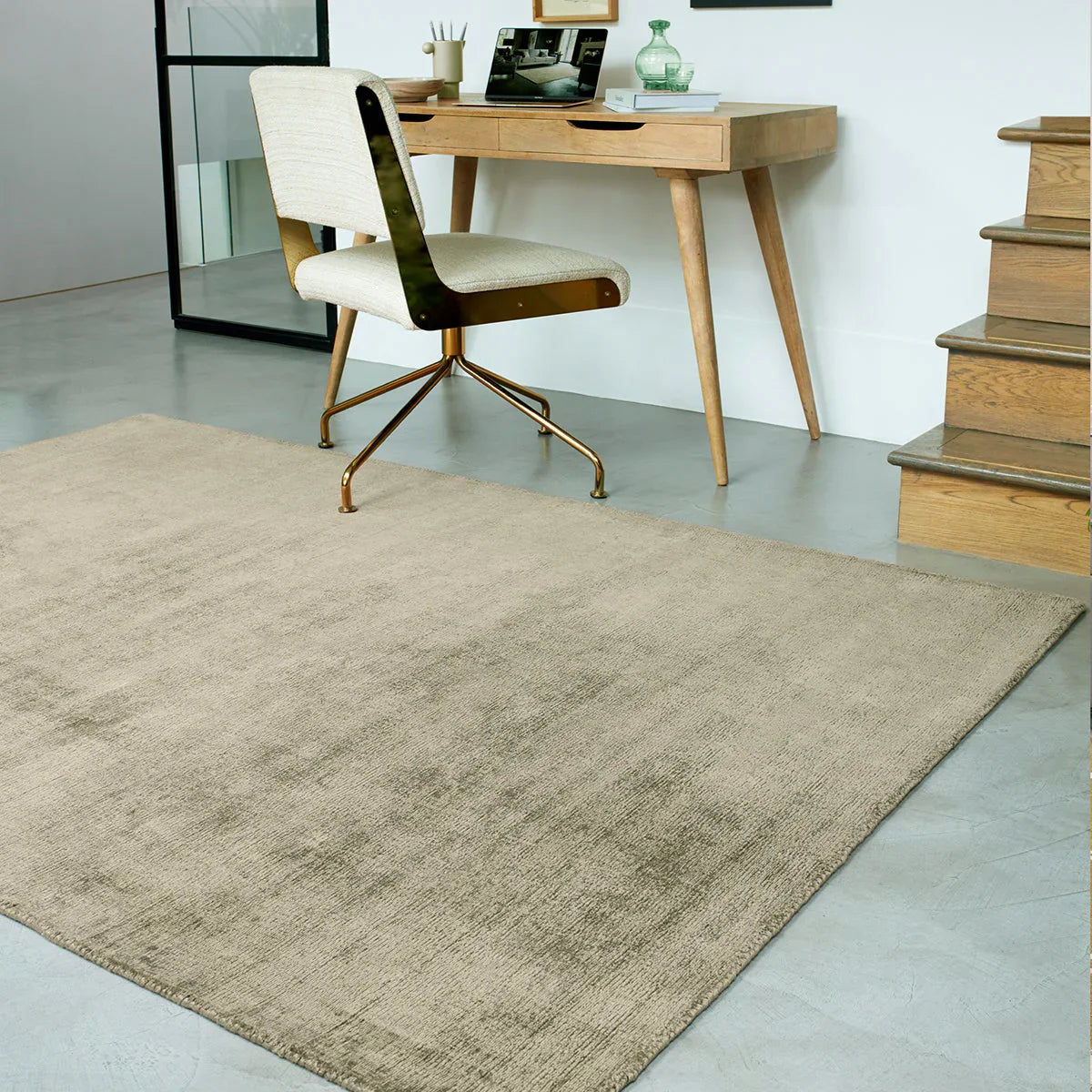 Asiatic Blade Sage Designer Rug featuring a plain texture in beige, taupe and cream on light grey floor, power-loomed wool