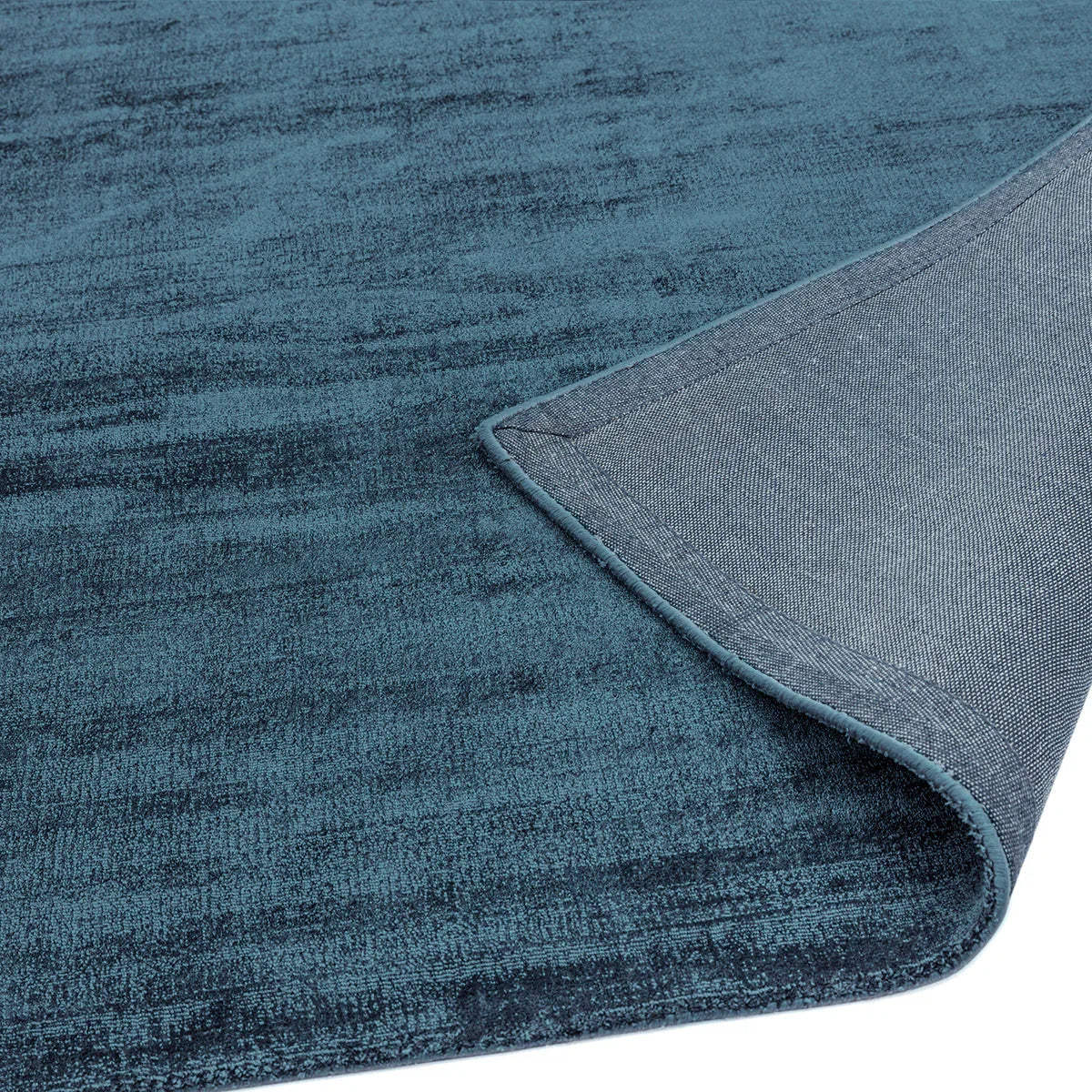 Asiatic Blade Teal Runner featuring distressed texture in teal, blue-teal and navy on white backdrop, machine-made wool