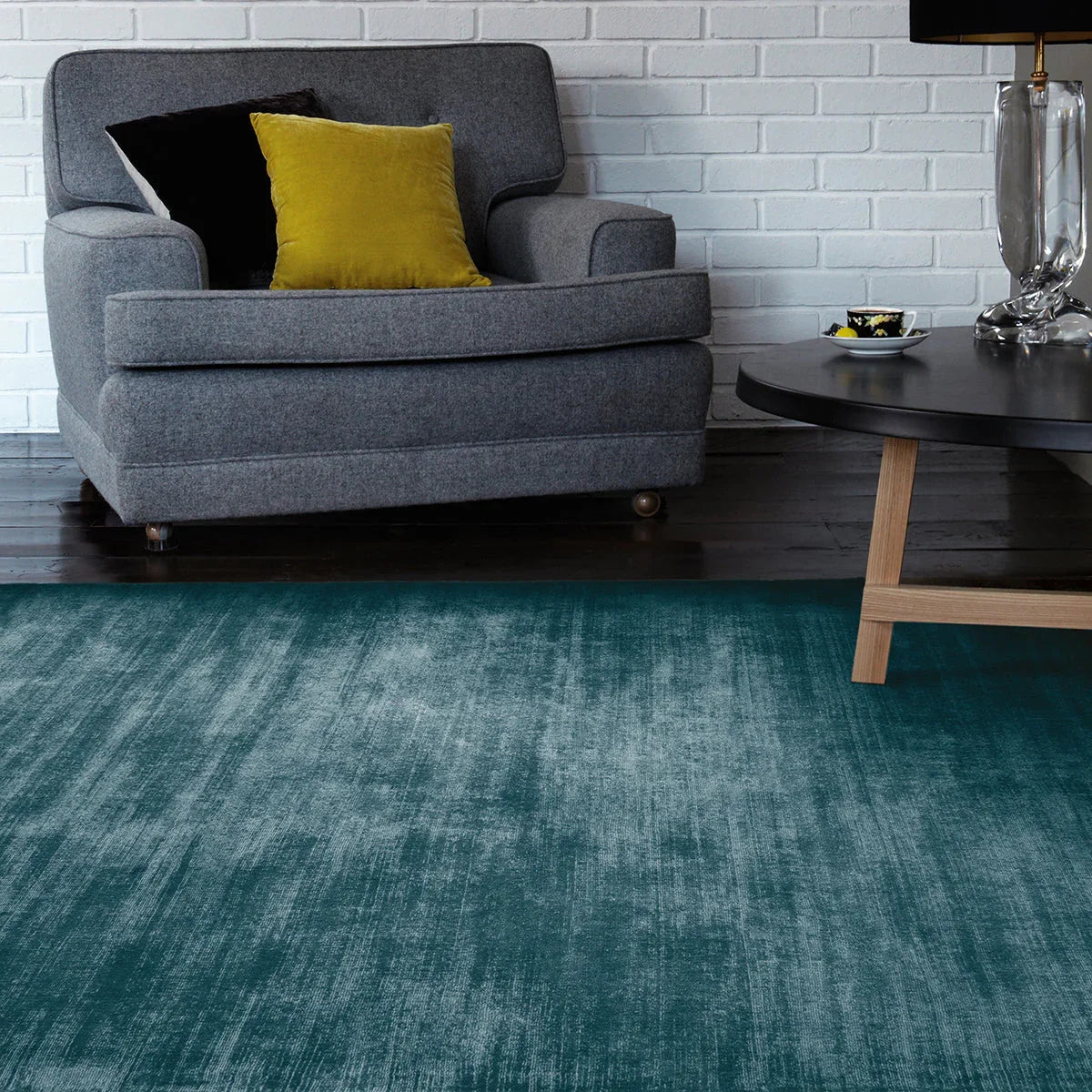 Asiatic Blade Teal Designer Rug featuring teal turquoise sea-green gradient on dark brown floor, hand-tufted wool