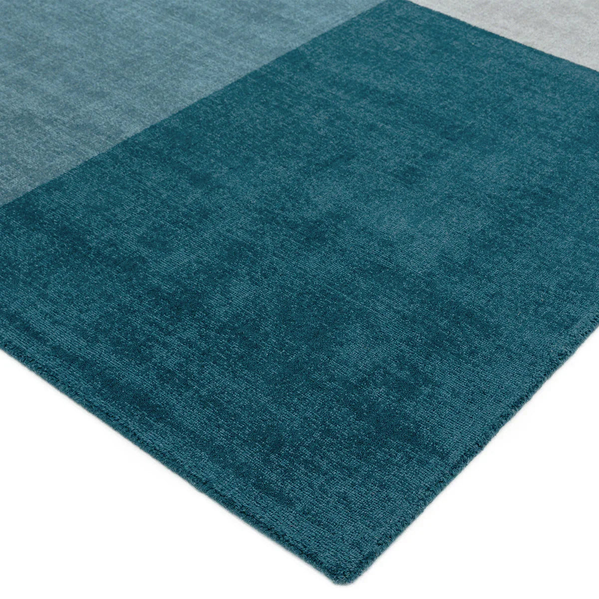 Asiatic Blox Teal Designer Rug with block pattern in teal, dark teal and sea-teal on teal backdrop, hand-tufted wool