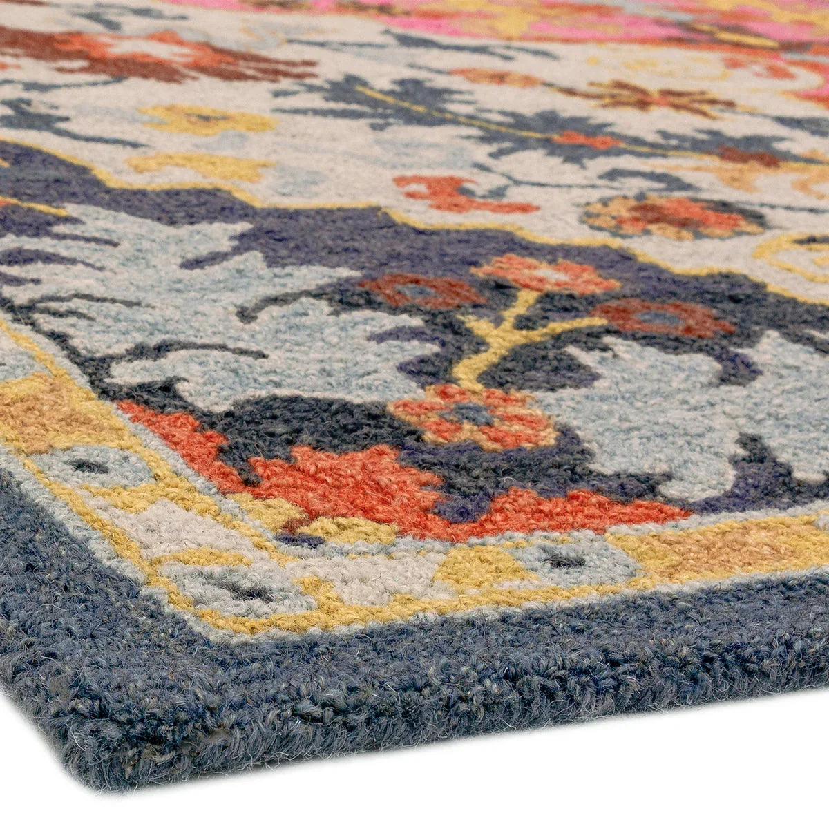 Asiatic Bronte Rug featuring ornate floral pattern in navy blue, cream and light blue on ivory background, tufted wool