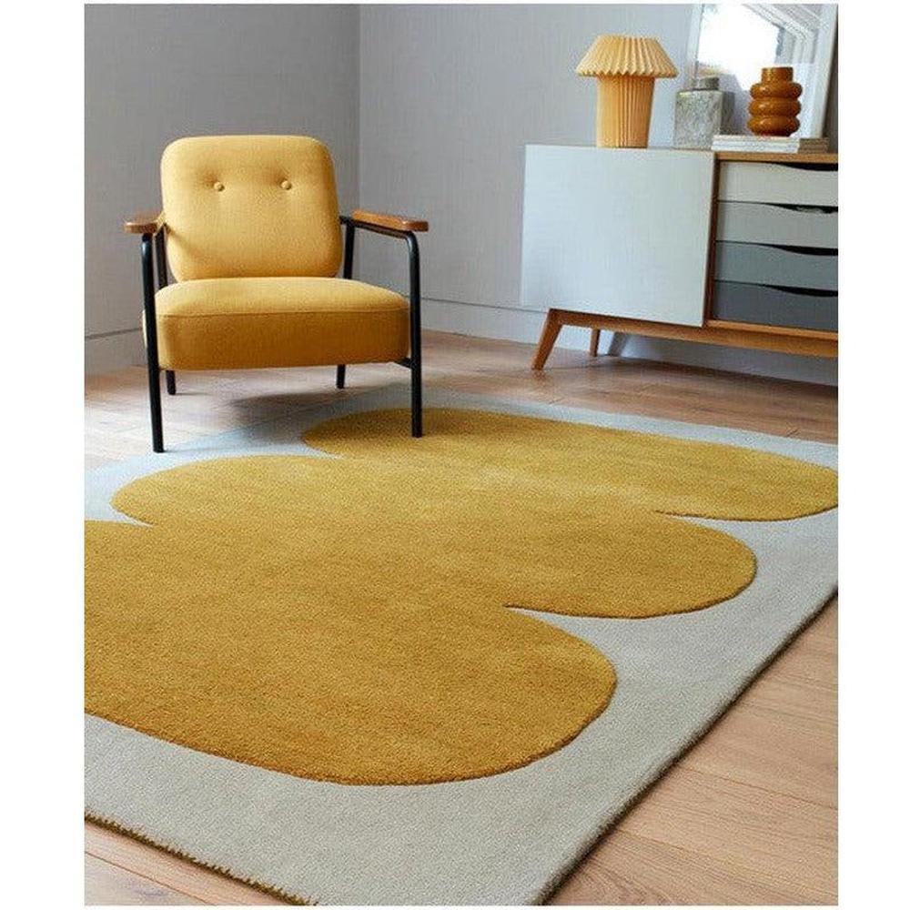 Asiatic Sculpt Gold Designer Rug featuring oversized floral motif in mustard yellow on pale grey background, hand-tufted wool