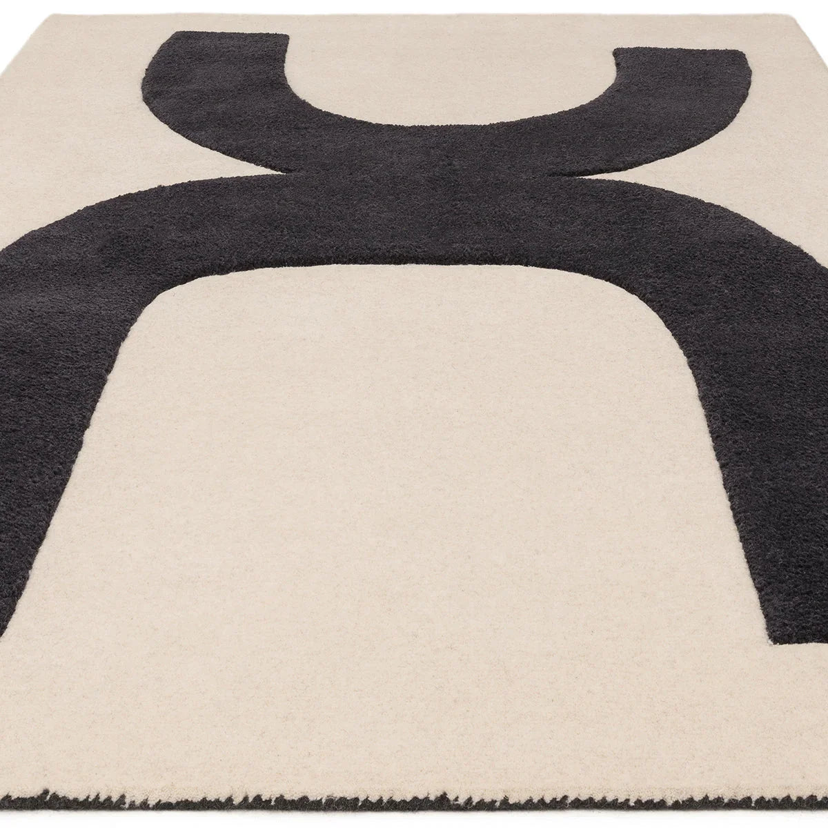 Asiatic Canvas 03 Balance Designer Rug featuring abstract curved motif in charcoal on beige background, hand-tufted wool