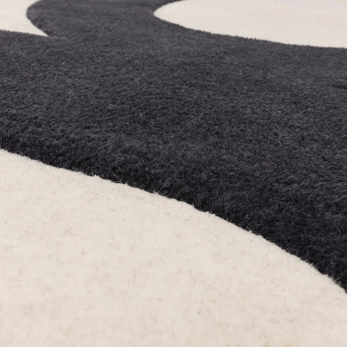 Asiatic Canvas 03 Balance Designer Rug curved pattern in navy blue, charcoal and ivory on cream, hand-tufted wool