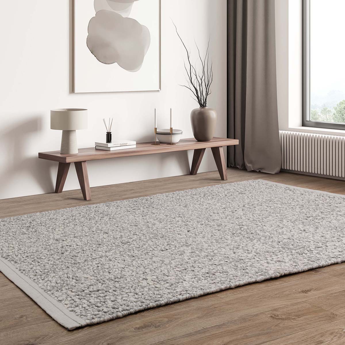Living room with a gray rug, wooden bench, and decorative items.