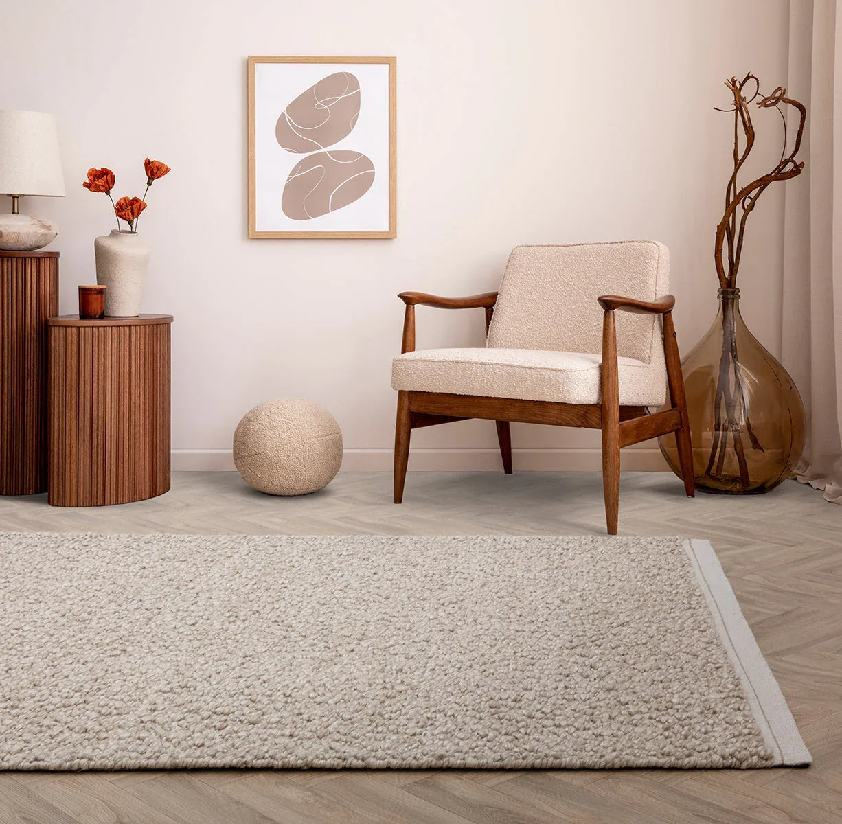 Living room with a beige armchair, wooden side table, and decorative elements.