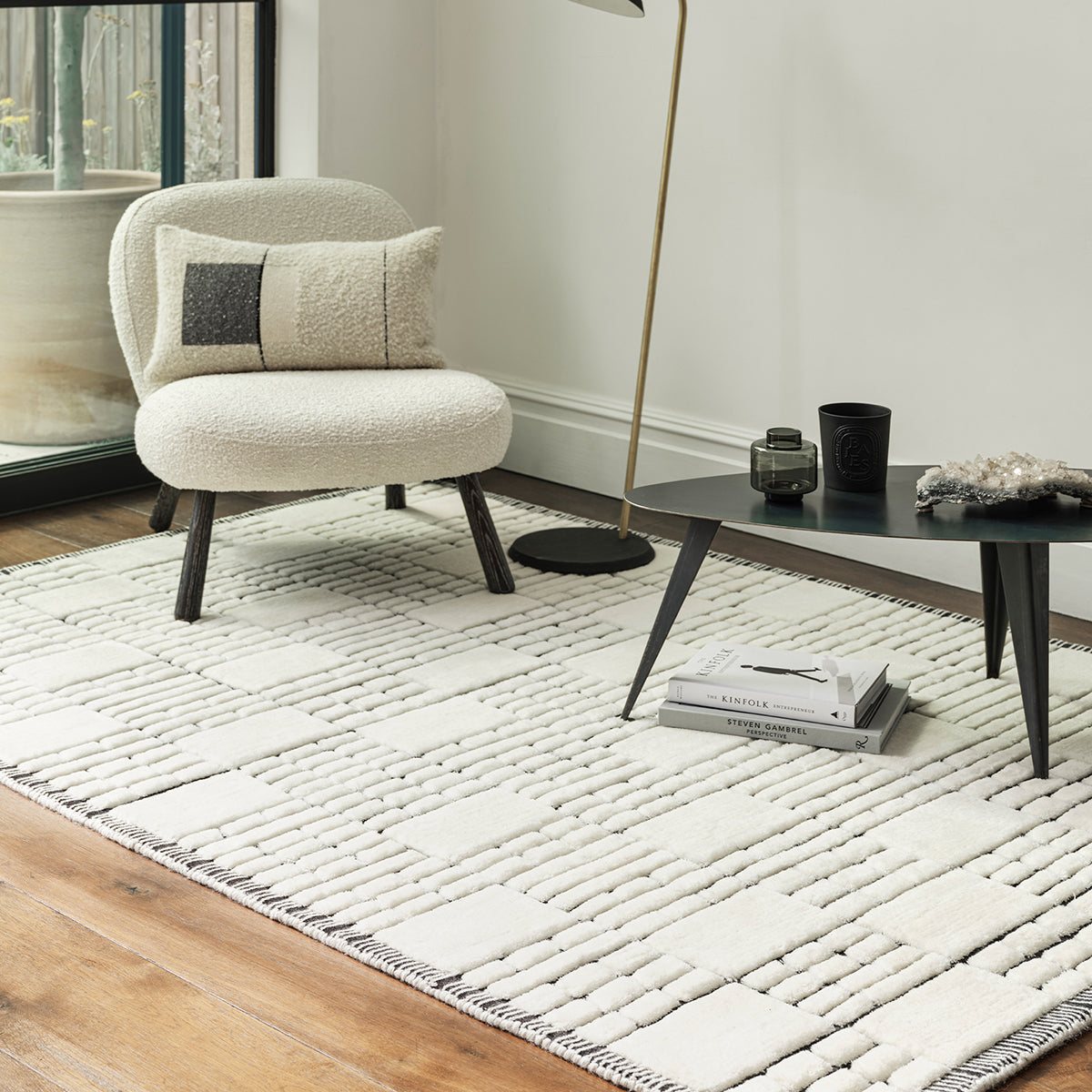 Modern living room with a textured area rug, chair, and coffee table.