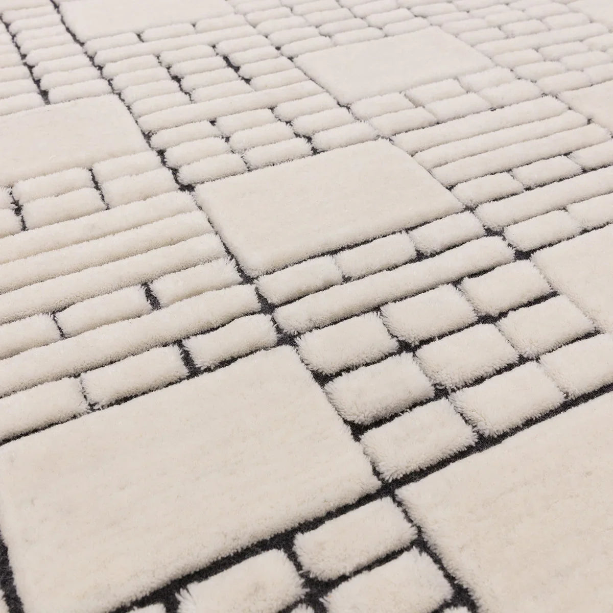 Asiatic Empire Rug featuring geometric rectangular blocks in cream and black on cream background, hand-tufted wool