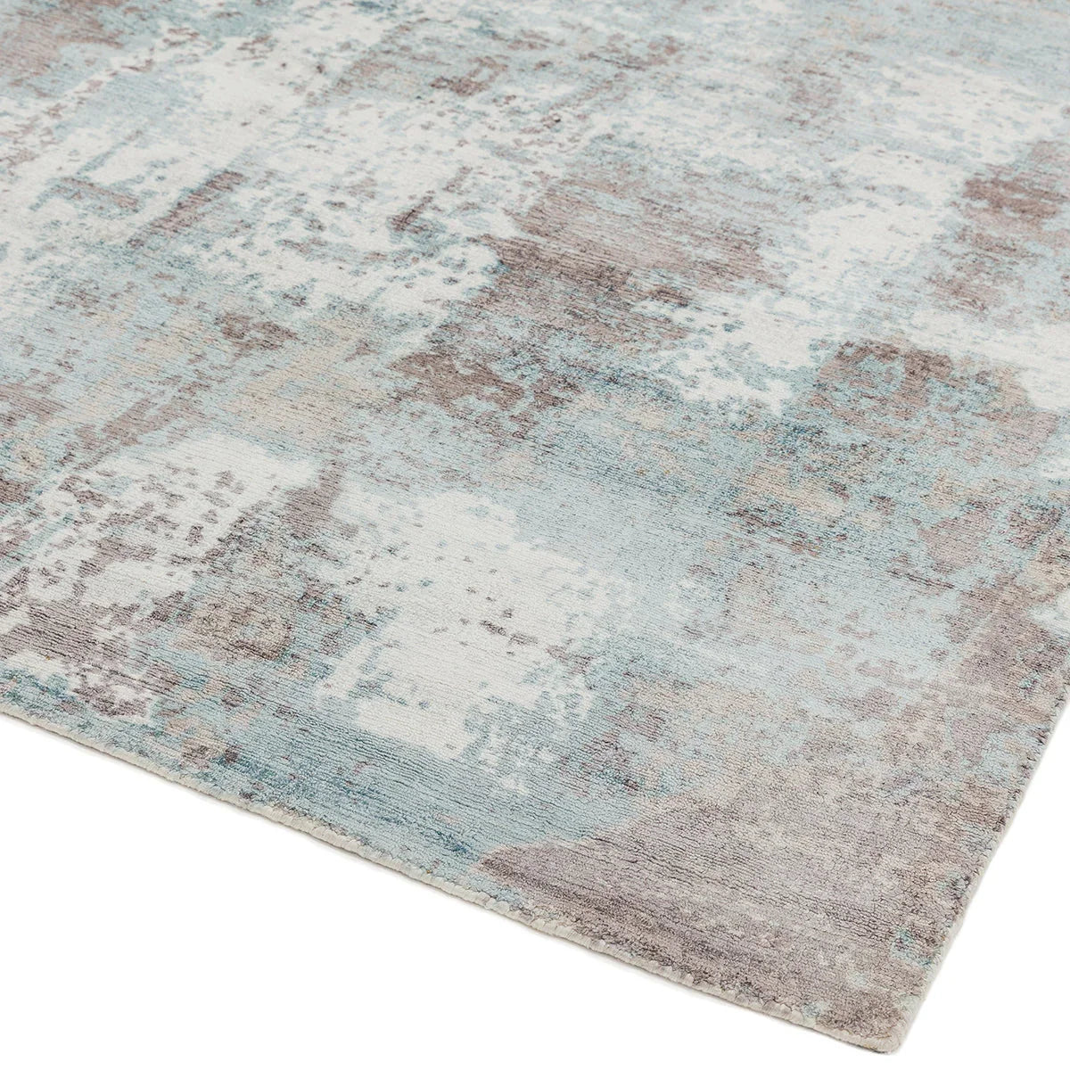 Asiatic Gatsby Blue Designer Rug featuring abstract distressed pattern in light blue, steel blue, cream and taupe on pale blue background, hand-tufted wool blend