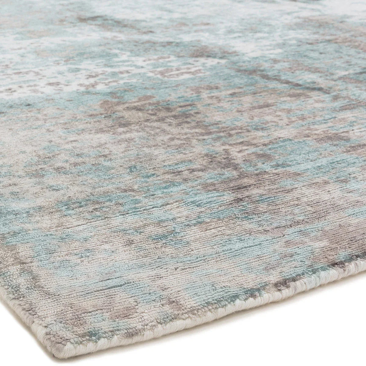 Asiatic Gatsby Blue Designer Rug featuring distressed abstract pattern in teal blue, sky blue and beige on ivory background, hand-tufted wool