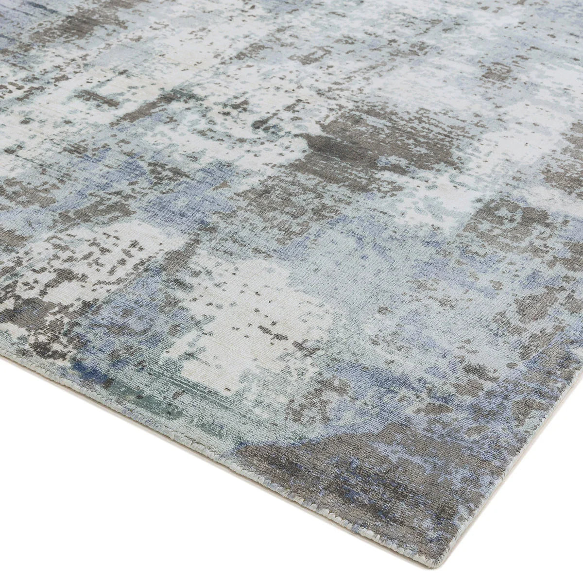 Asiatic Gatsby Navy Designer Rug featuring distressed abstract pattern in navy, light blue, taupe and cream on light background, machine-woven wool blend
