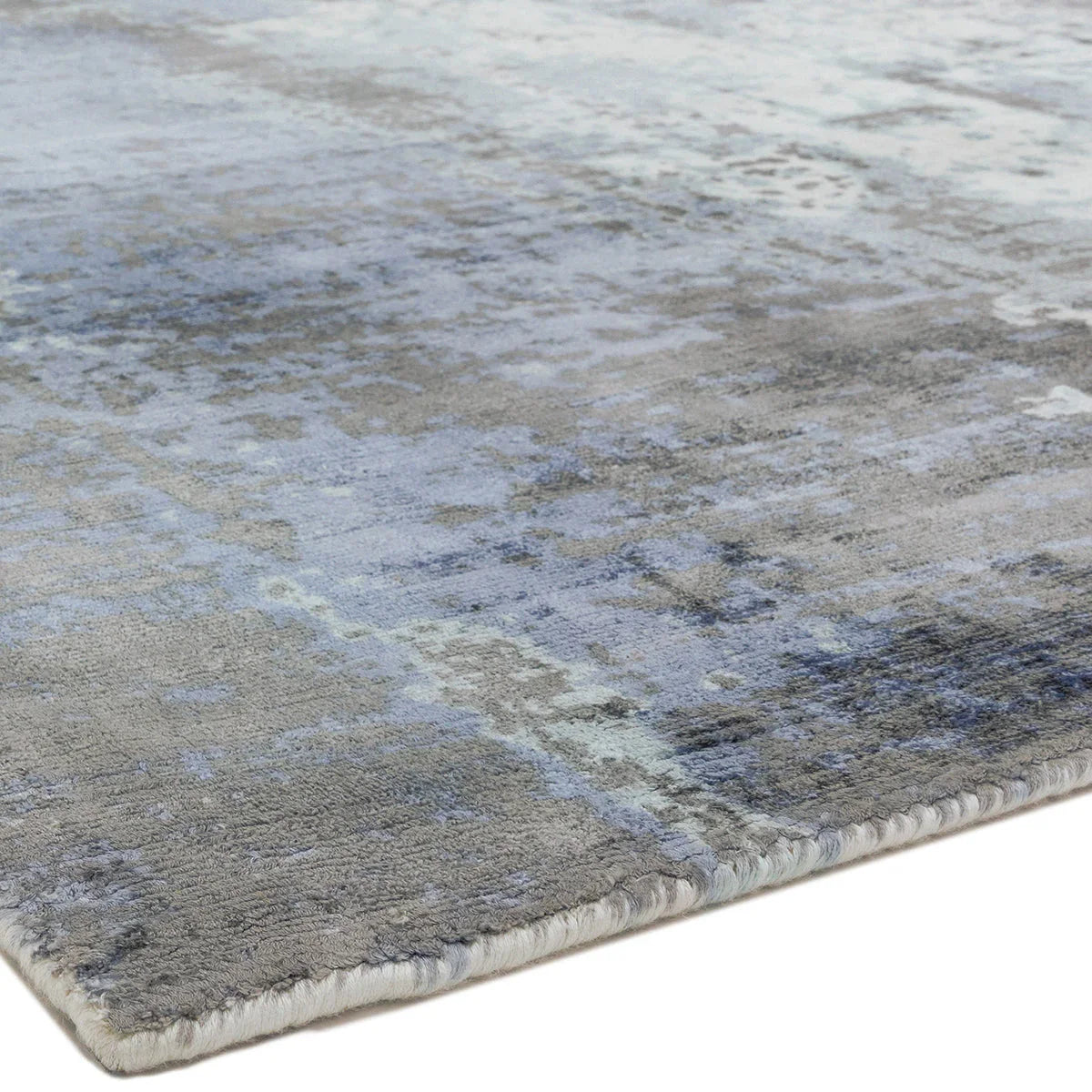 Asiatic Gatsby Navy Designer Rug featuring abstract mottled pattern in navy blue, blue-grey and grey on light beige background, hand-tufted wool