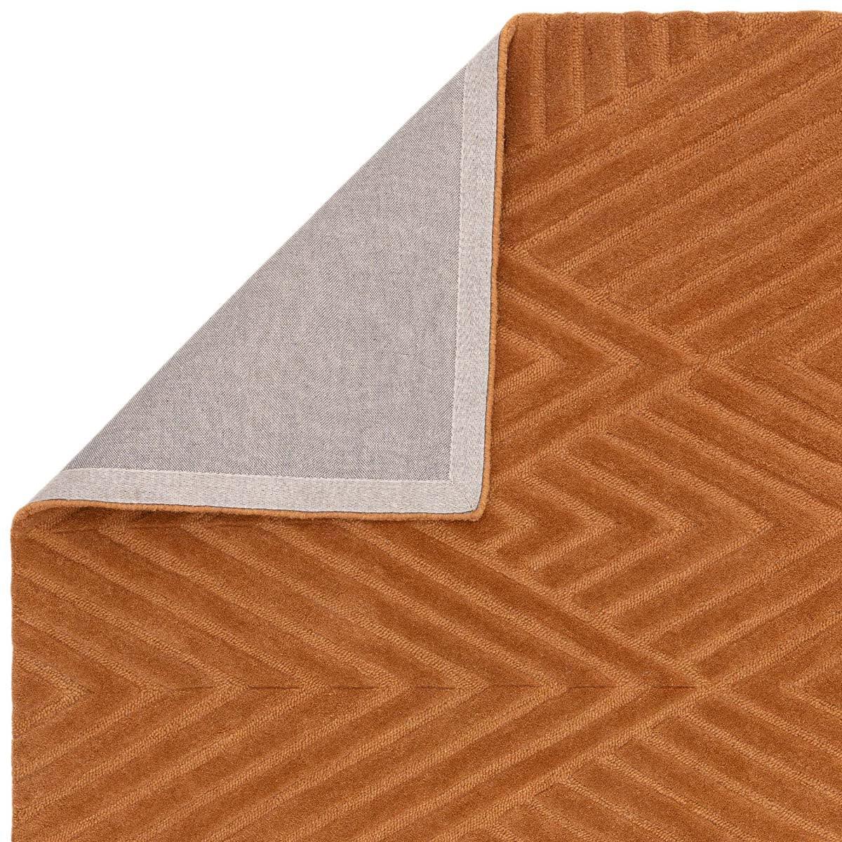 Asiatic Hague Desert Designer Rug featuring chevron pattern in copper brown, tan and beige on warm brown background, hand-tufted wool