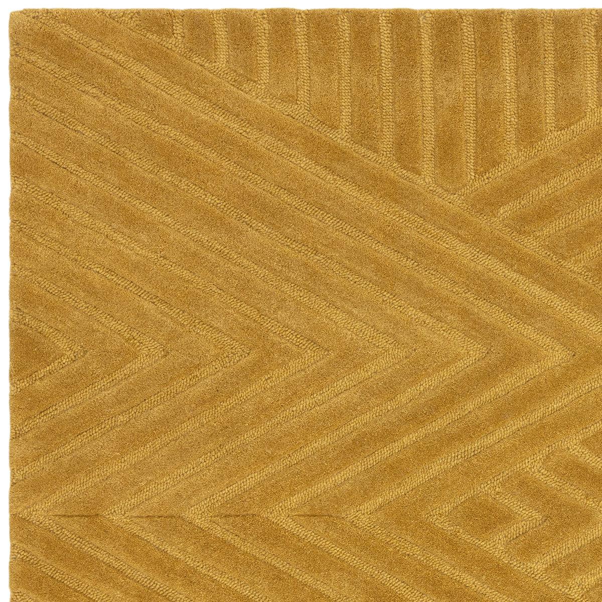 Asiatic Hague Ochre Designer Rug featuring chevron geometric pattern in ochre and golden tones on warm ochre background, hand-tufted wool