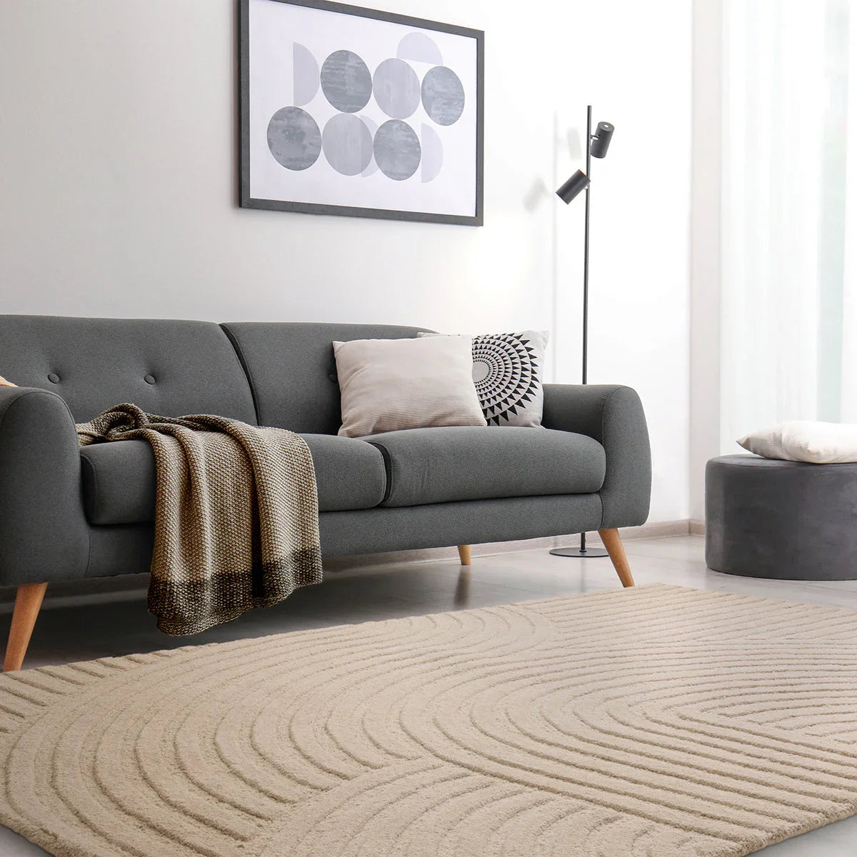 Asiatic Hague Sand Designer Rug featuring circular swirl pattern in sand, ivory and taupe on beige background, machine-woven rug