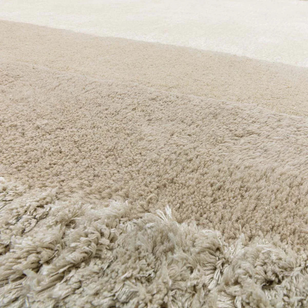 Asiatic Halo Calico Oval Rug featuring shaggy pattern in cream, beige and tan on light beige background, hand-tufted wool