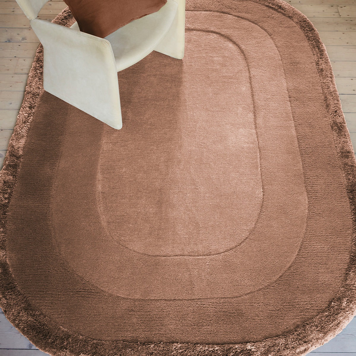 Brown bath mat on a wooden floor