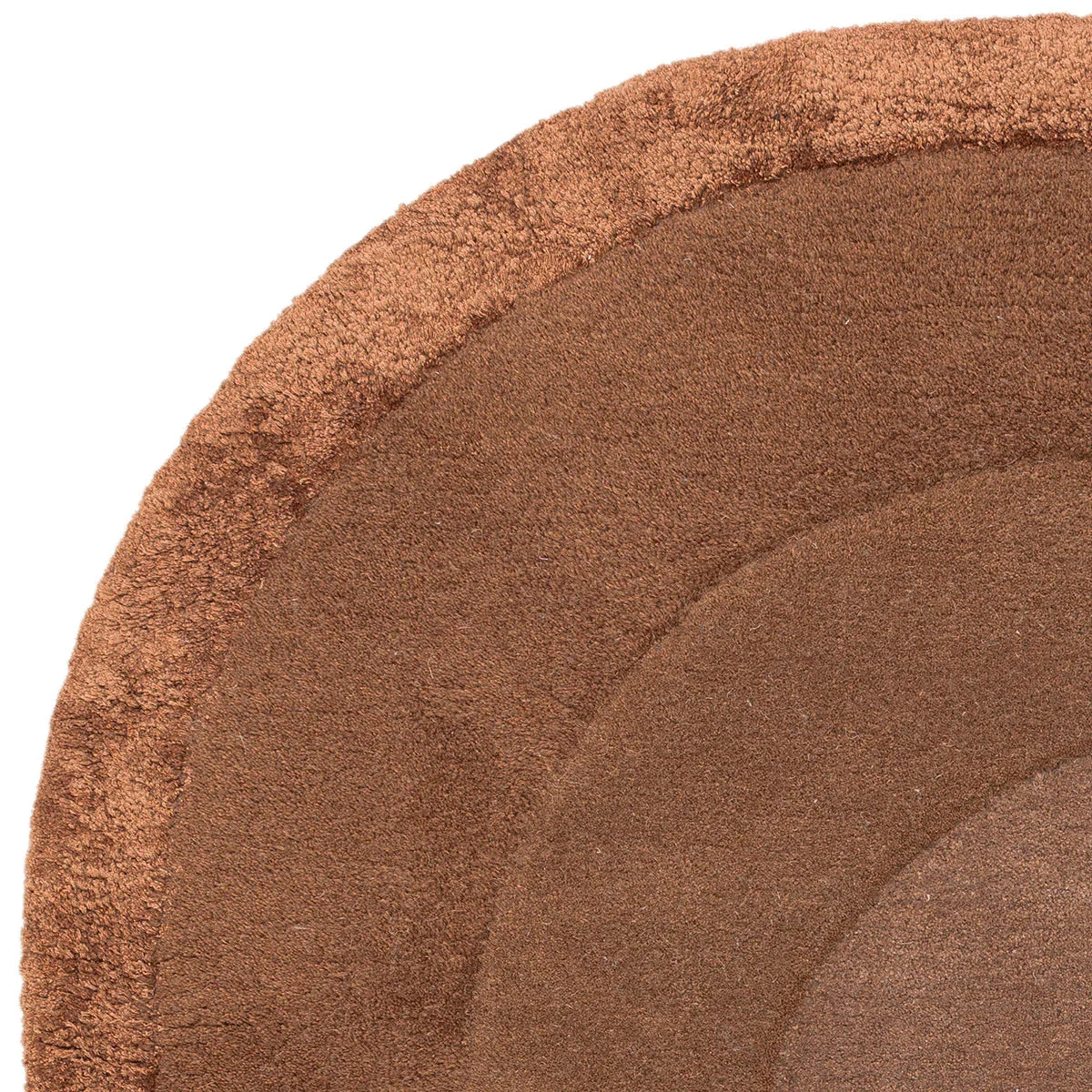 Asiatic Halo Clay rug featuring circular halo design in clay brown on warm beige background, hand-tufted wool
