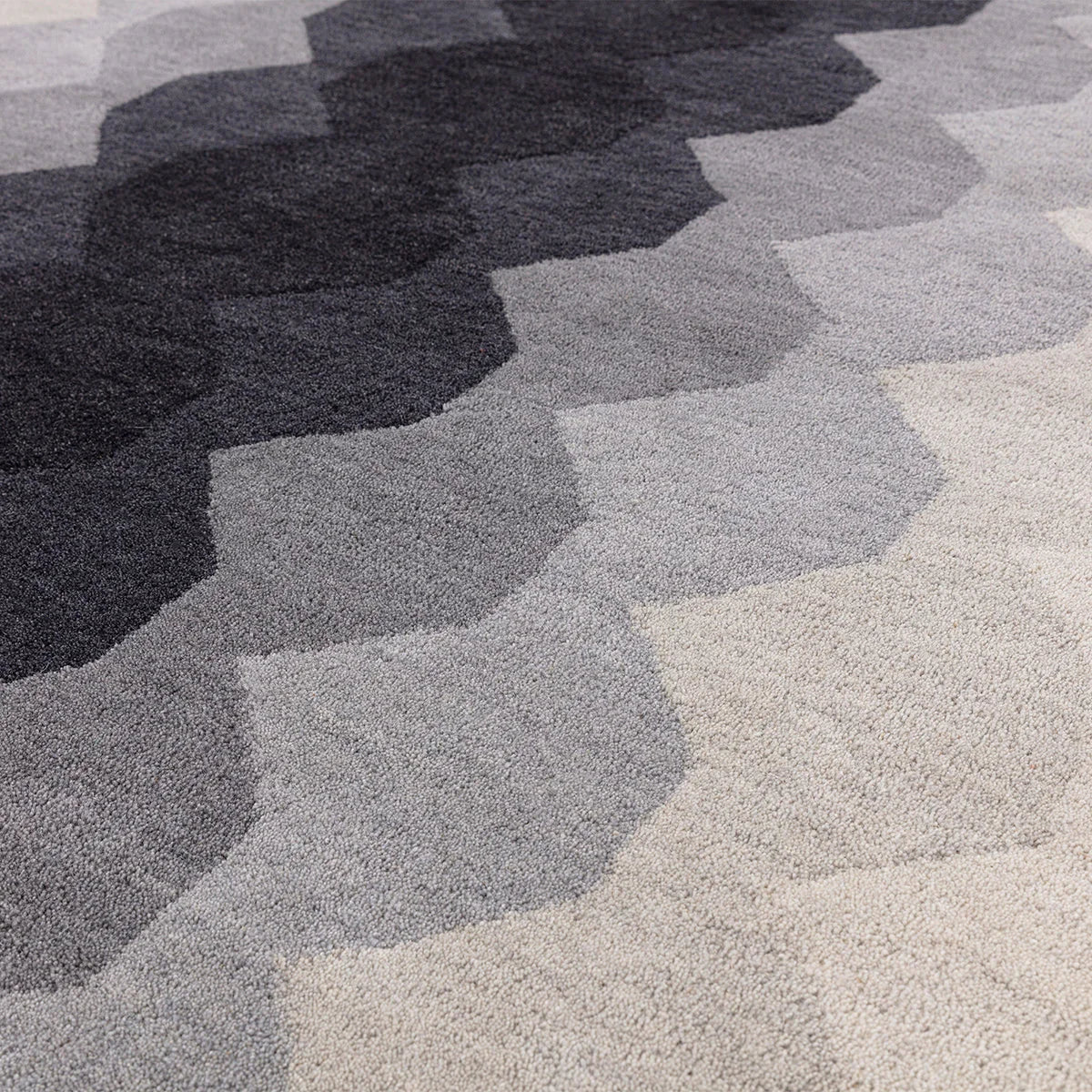 Asiatic Hive Charcoal Runner featuring honeycomb geometric pattern in charcoal, dark grey, mid grey, light grey and beige on cream background, hand-tufted wool