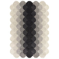 Woven patterned rug with black, gray, and beige colors on a white background
