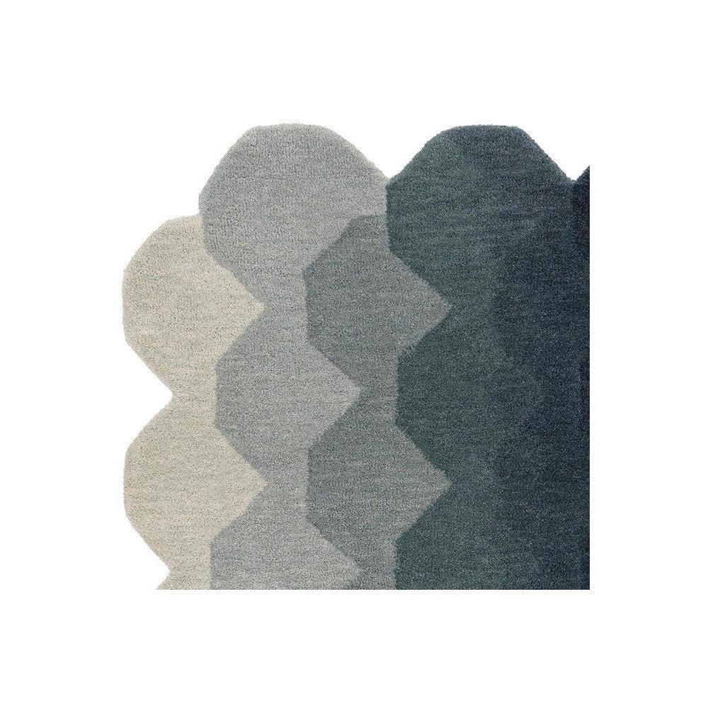 Asiatic Hive Teal Designer Rug featuring overlapping hexagon pattern in cream, light gray and teal on dark teal background
