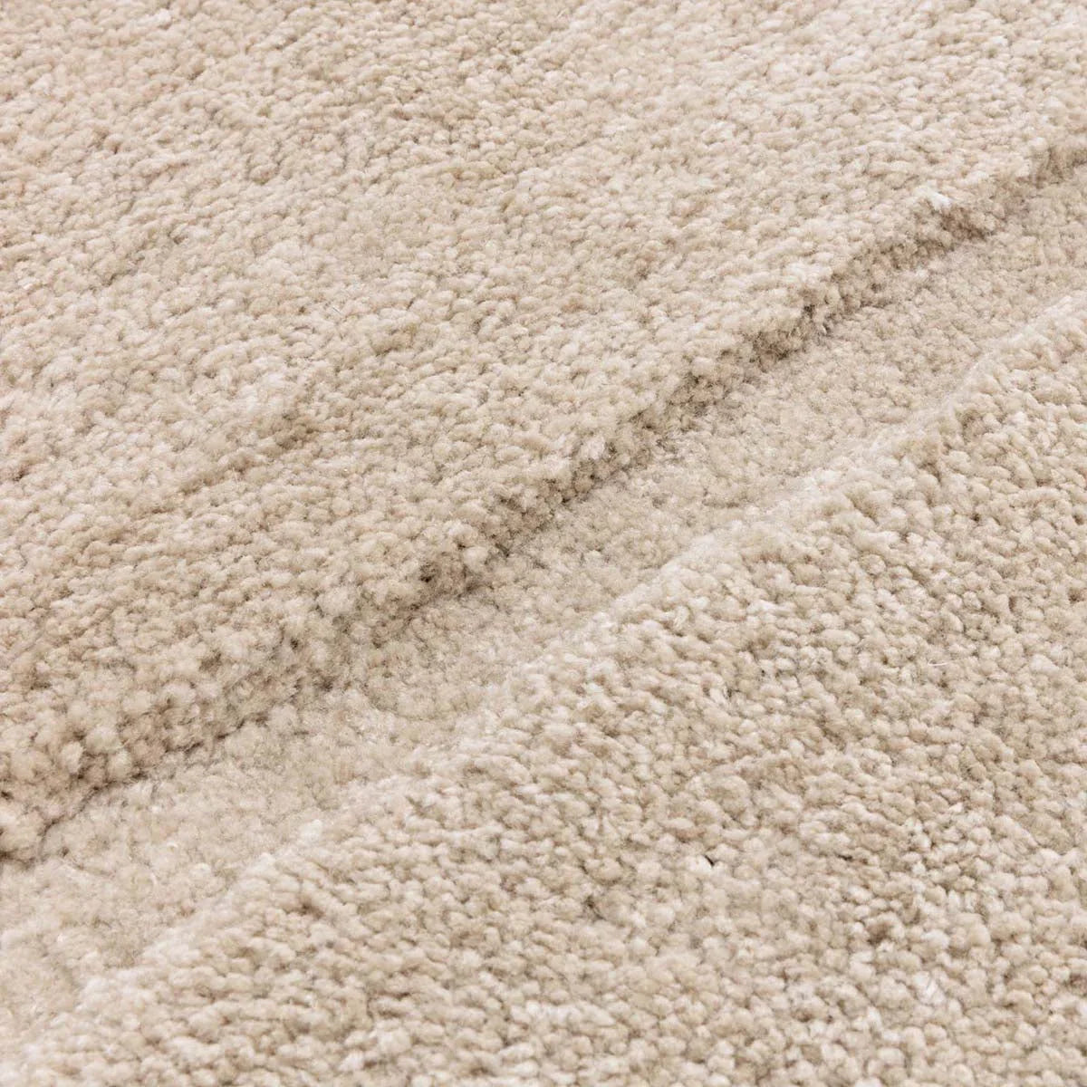 Asiatic Horizon Sand designer rug featuring solid shag texture in sand and cream on warm beige background, hand-tufted wool