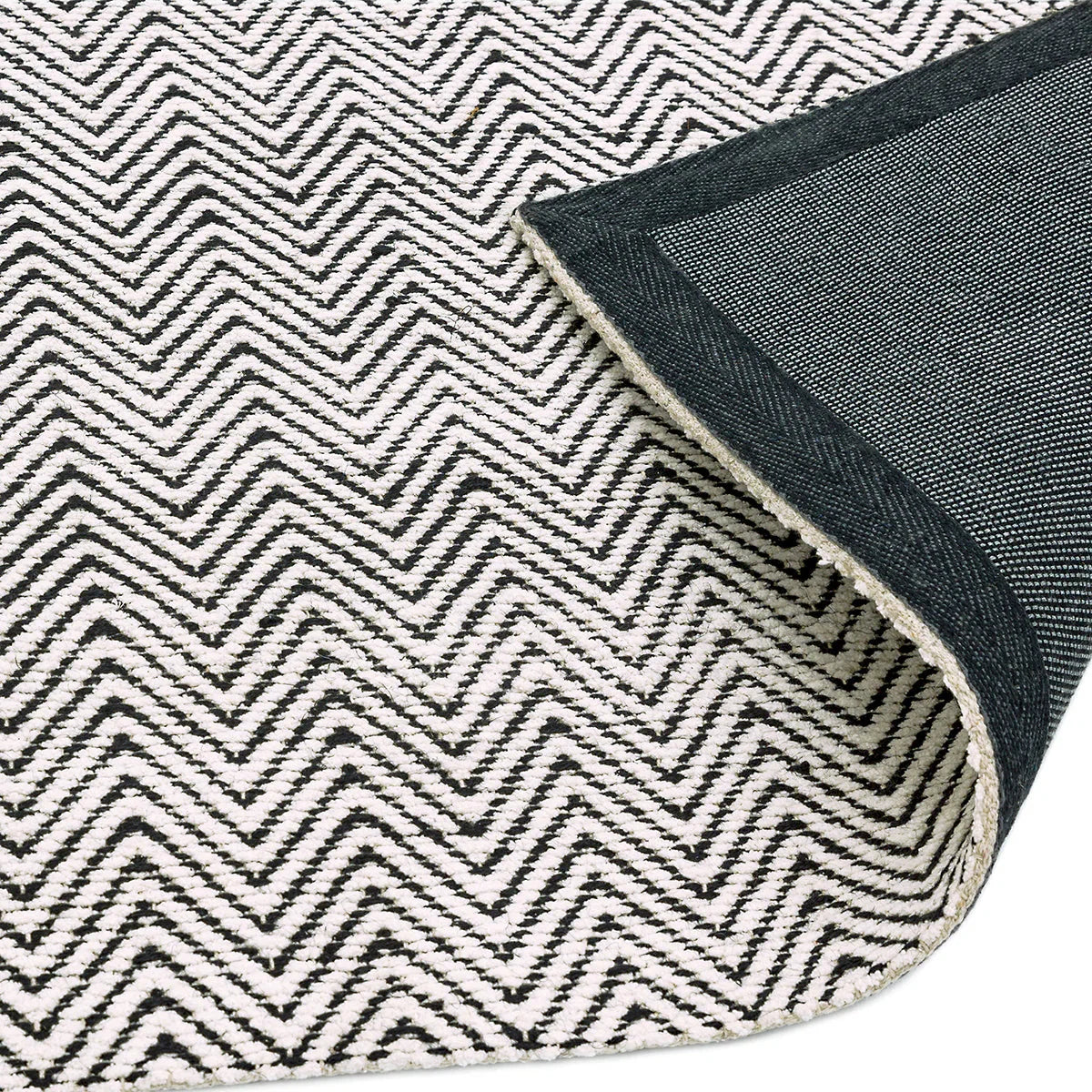 Asiatic Ives Black White Designer Rug featuring chevron pattern in black, white and indigo on light background, machine-woven wool