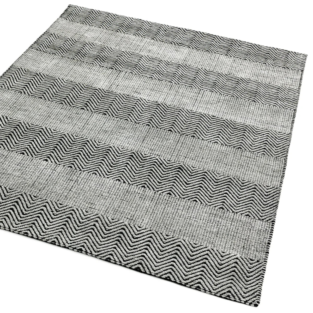 Asiatic Ives Grey Designer Rug featuring chevron zigzag pattern in black, charcoal and light grey on pale grey background, hand-tufted wool