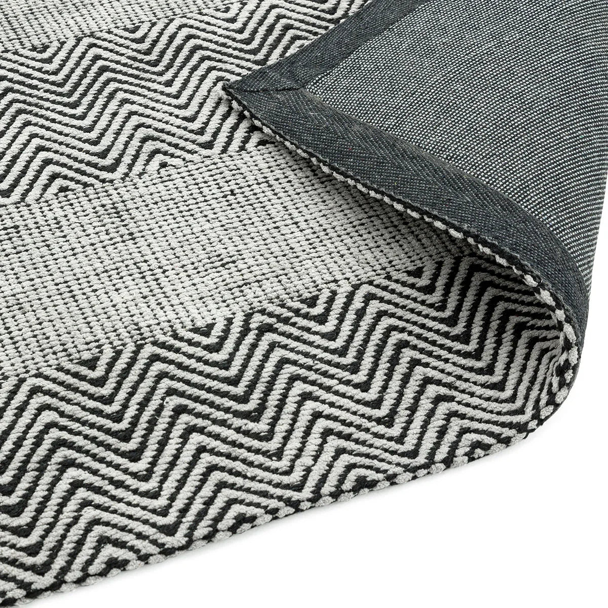 Asiatic Ives Grey Designer Rug featuring geometric chevron pattern in charcoal-black, ivory and light grey on medium grey background, woven wool