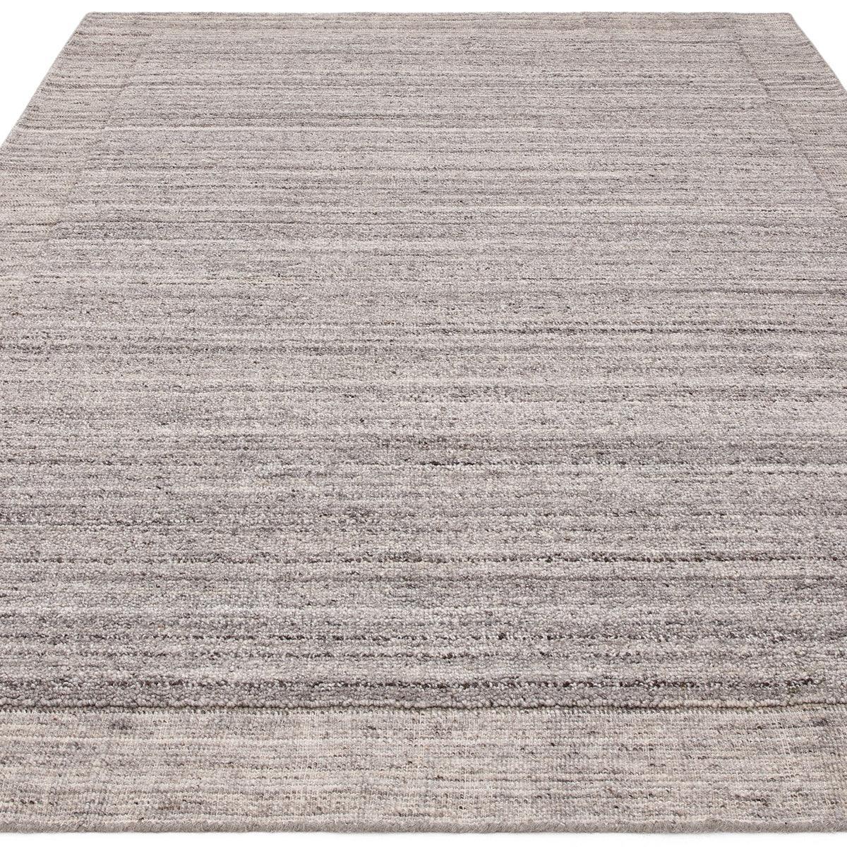 Asiatic Larson Charcoal rug featuring textured stripe pattern in charcoal, grey and cream on light beige background, hand-tufted wool