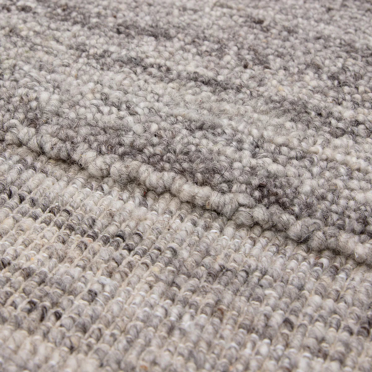 Asiatic Larson Charcoal Rug featuring textured loop pile in charcoal, grey and cream on beige background, hand-tufted wool