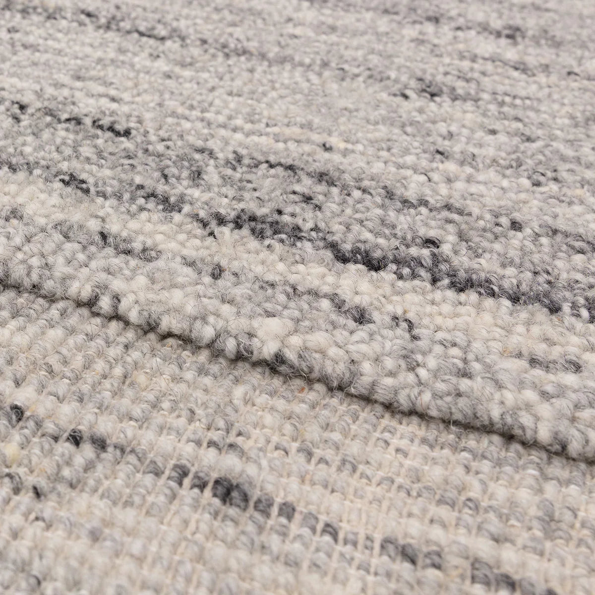 Asiatic Larson Grey Designer Rug featuring subtle speckled abstract pattern in charcoal grey, grey and ivory on light grey background, hand-tufted wool